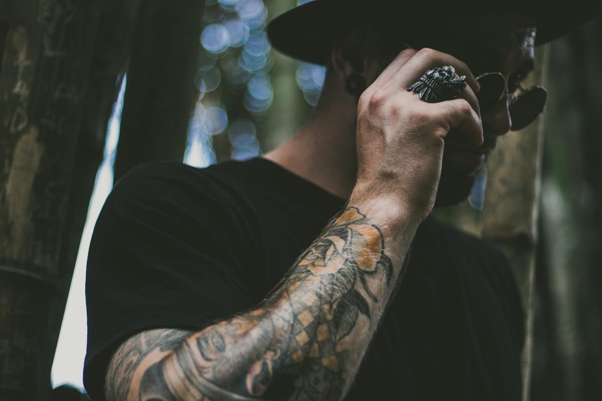 photo of man holding his sunglasses