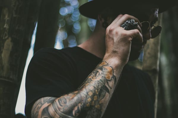 photo of man holding his sunglasses